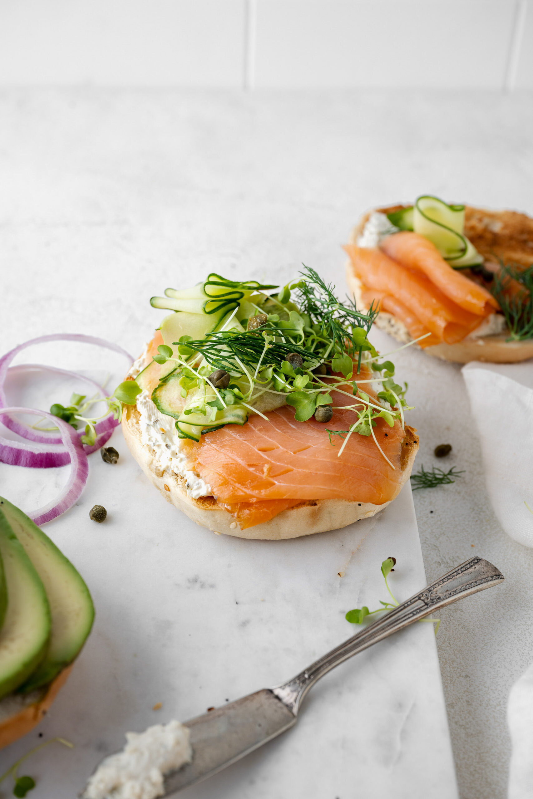 Smoked salmon bagel with cream cheese, cucumber ribbons, and fresh dill - omega-3 rich foods for better sleep women over 60