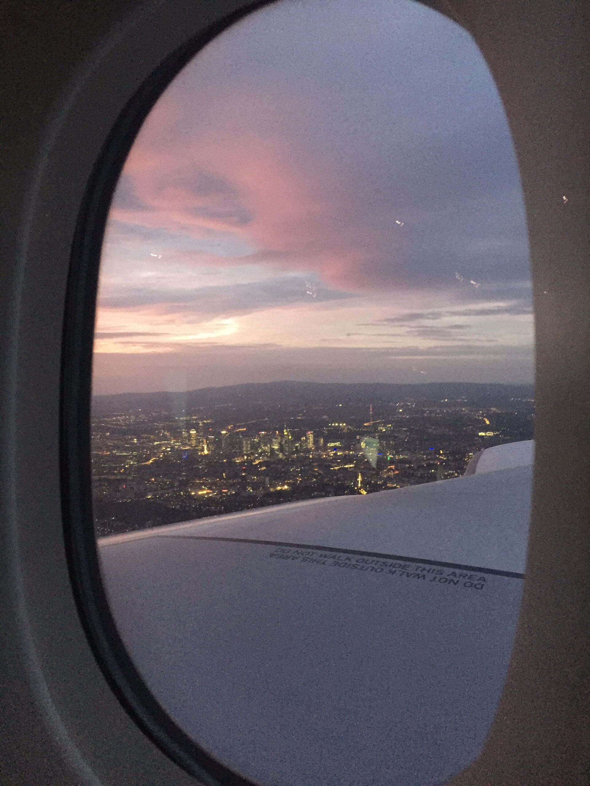 looking out at a city through an airplane window free from fear of flying