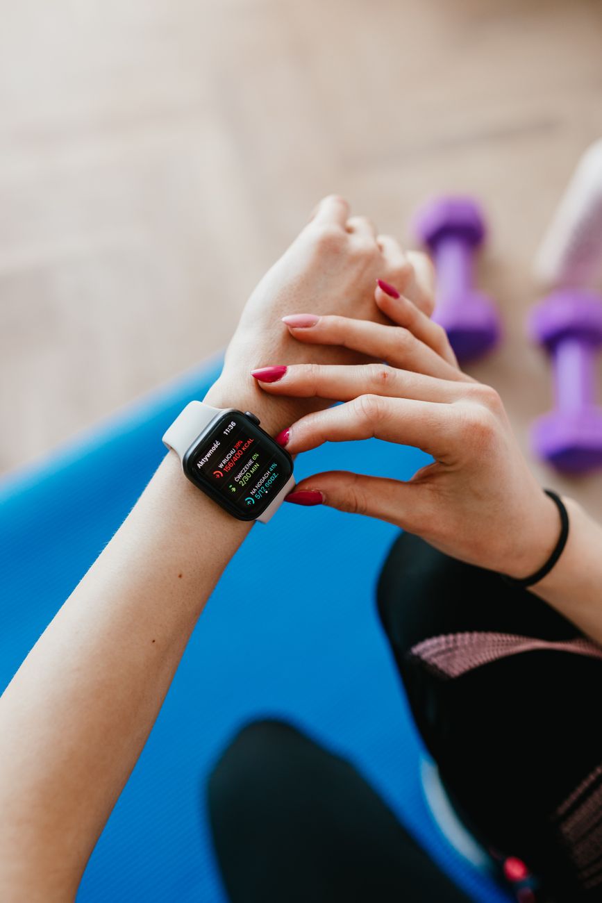 faceless woman with smart watch on mat